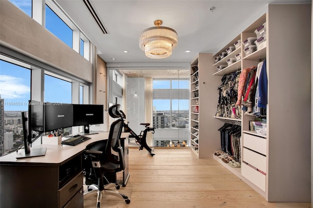 office space featuring plenty of natural light and light hardwood / wood-style floors