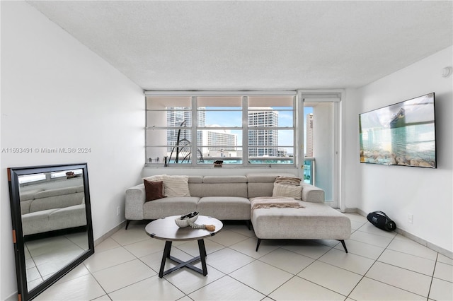 living room featuring light tile patterned flooring and a textured ceiling