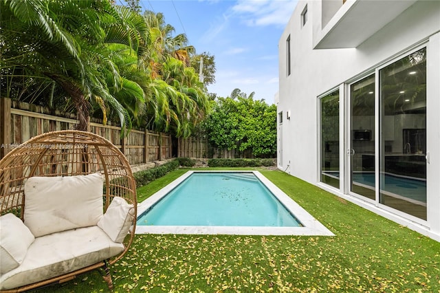 view of swimming pool featuring a lawn