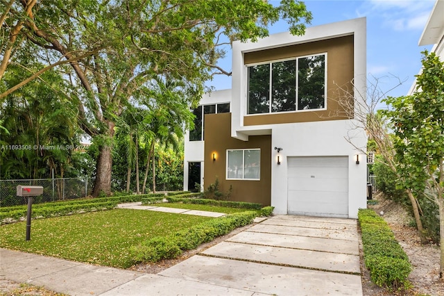 modern home featuring a garage and a front yard