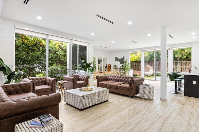 1816 SW 23rd St, Miami, FL 33145 - living room with light wood finished floors, recessed lighting, and expansive windows