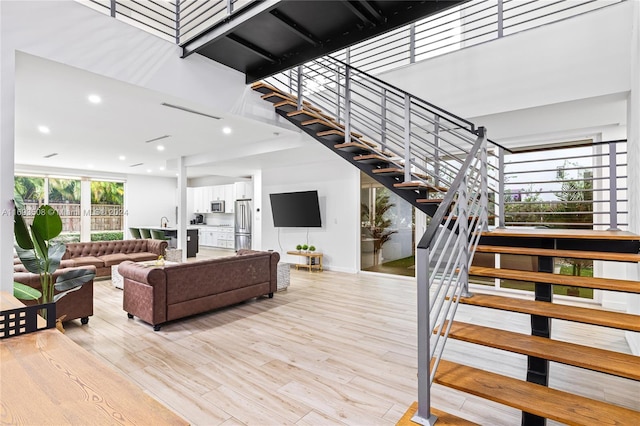 1816 SW 23rd St, Miami, FL 33145 - stairway featuring wood finished floors, a high ceiling, and recessed lighting