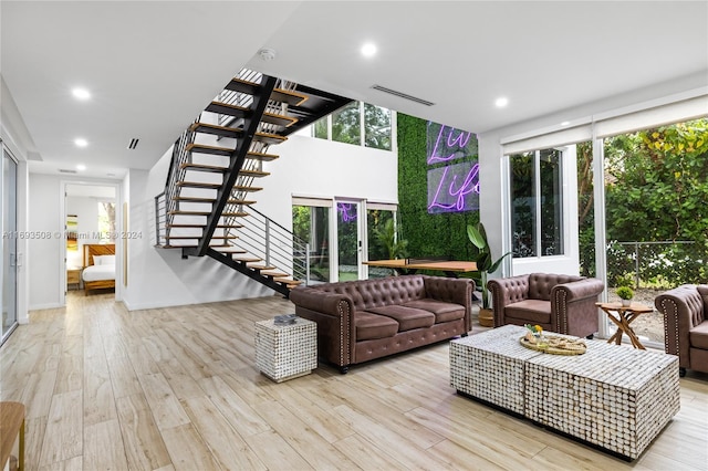 living room with expansive windows and light wood-type flooring