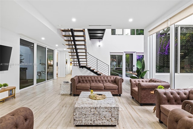 1816 SW 23rd St, Miami, FL 33145 - living room featuring stairway, healthy amount of natural light, light wood finished floors, and recessed lighting