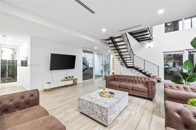 living room with light wood-type flooring and a healthy amount of sunlight