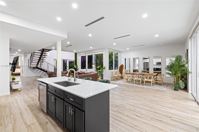 1816 SW 23rd St, Miami, FL 33145 - kitchen featuring open floor plan, dark cabinets, an island with sink, light wood-style flooring, and recessed lighting