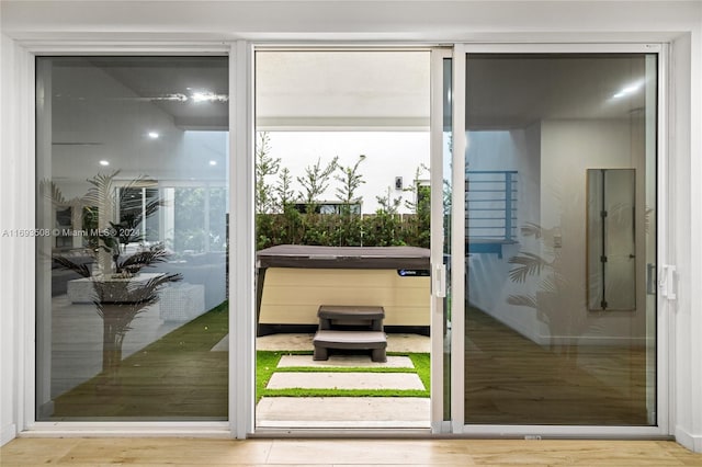 doorway to outside featuring hardwood / wood-style floors and a healthy amount of sunlight