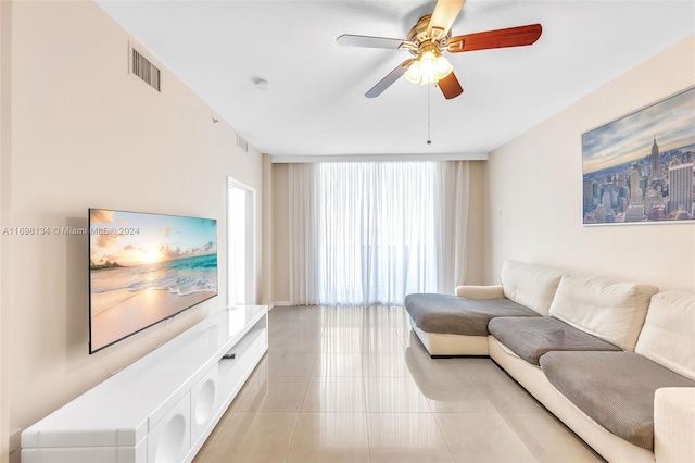 tiled living room featuring ceiling fan