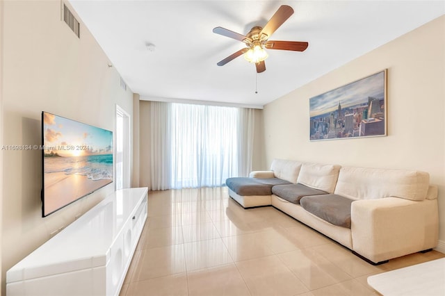 tiled living room featuring ceiling fan