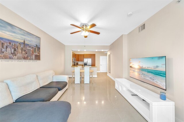 tiled living room featuring ceiling fan