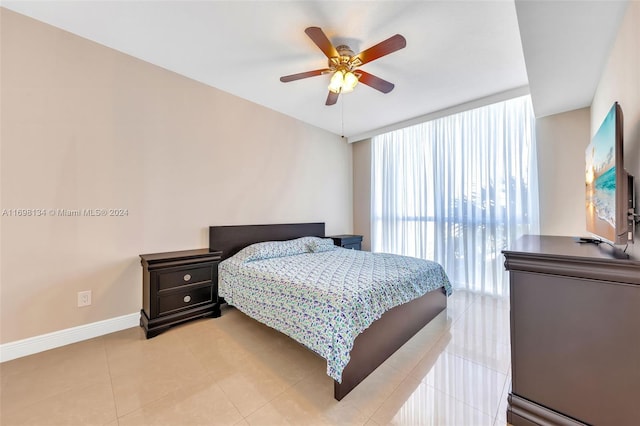 bedroom with ceiling fan and light tile patterned floors