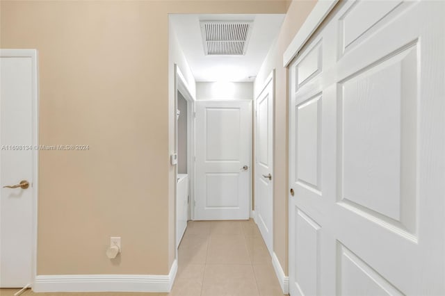 hall with light tile patterned flooring