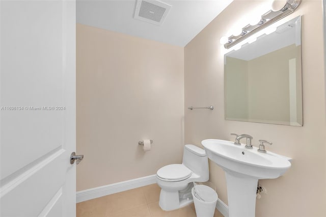 bathroom with sink, tile patterned flooring, and toilet