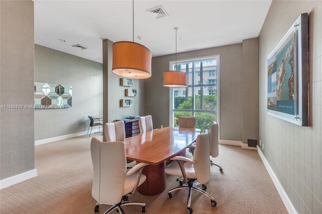 dining room with light colored carpet