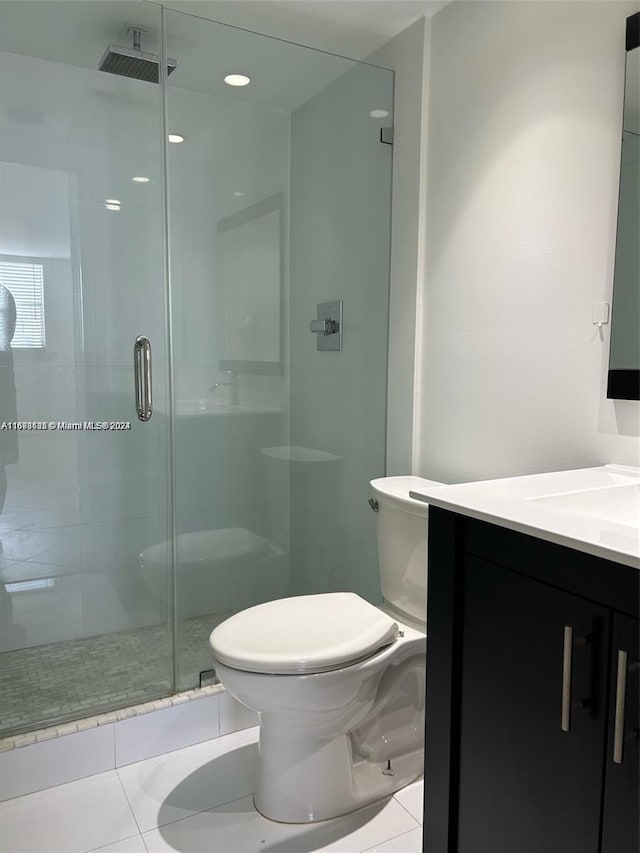 bathroom featuring tile patterned floors, walk in shower, vanity, and toilet