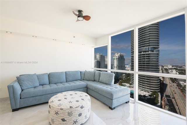 living room featuring expansive windows and ceiling fan