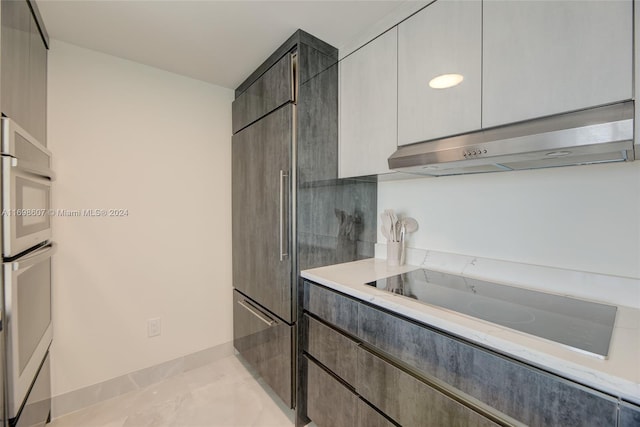 kitchen featuring light tile patterned floors, white double oven, black electric cooktop, and extractor fan