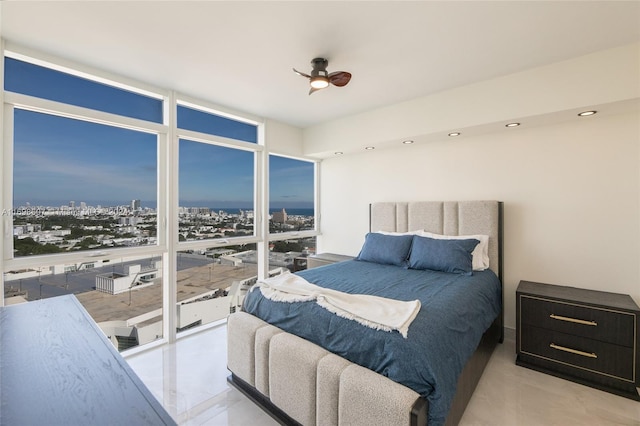 bedroom featuring ceiling fan and expansive windows