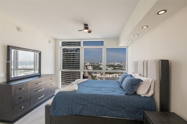 bedroom with ceiling fan and light wood-type flooring