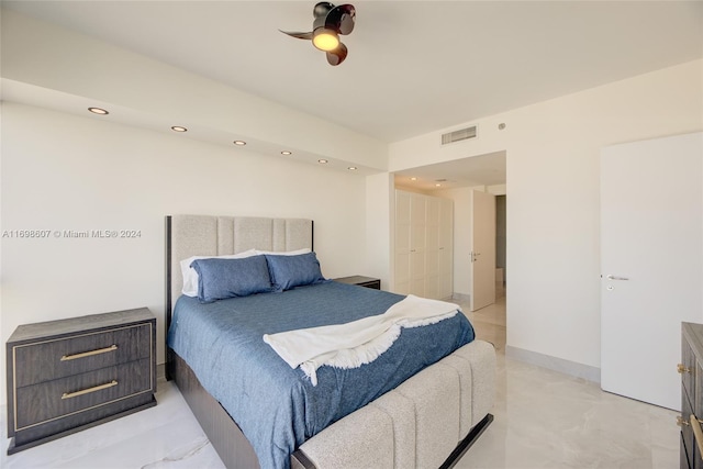 bedroom with ceiling fan and a closet