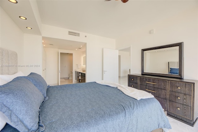 bedroom with light carpet and ensuite bath