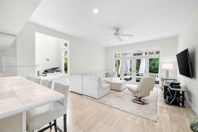 living room featuring ceiling fan and french doors