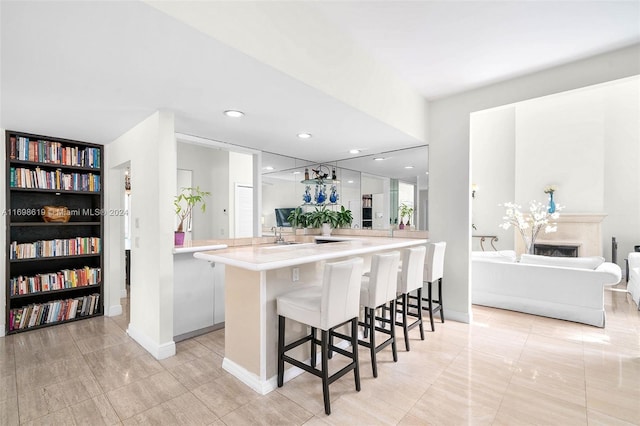 kitchen with kitchen peninsula, a kitchen breakfast bar, and white cabinets