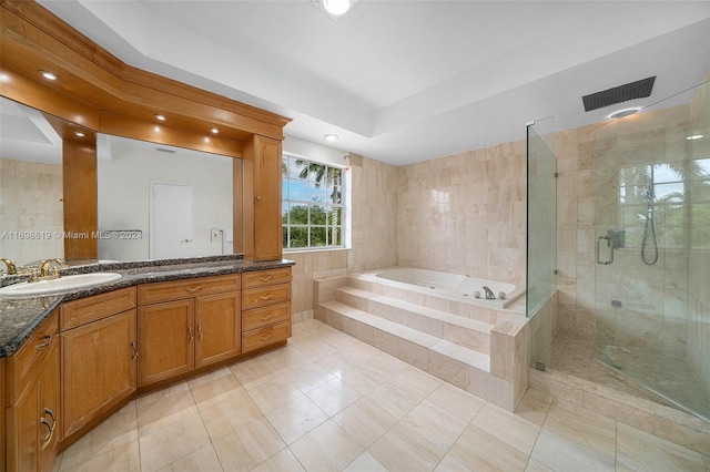 bathroom featuring a raised ceiling, tile patterned flooring, vanity, and shower with separate bathtub