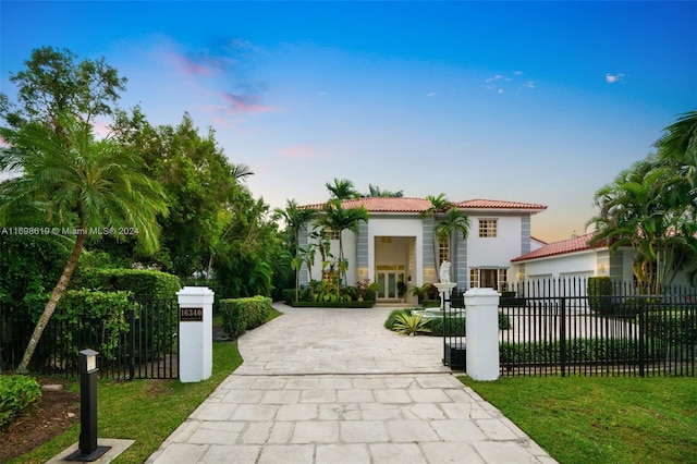 mediterranean / spanish house with a lawn