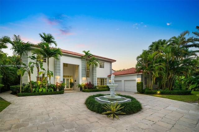 mediterranean / spanish-style house with french doors and a garage