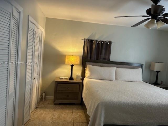 bedroom featuring light tile patterned floors and ceiling fan