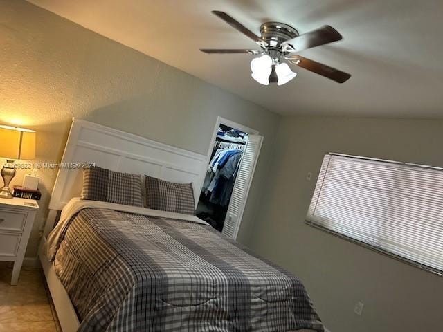 bedroom with ceiling fan and a closet