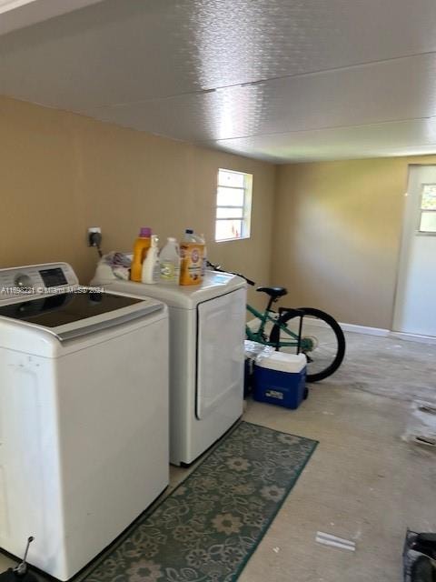 clothes washing area with washer and clothes dryer