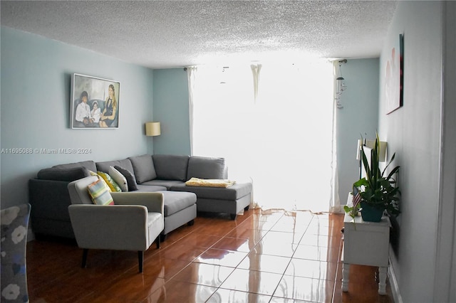 living room with tile patterned flooring and a textured ceiling