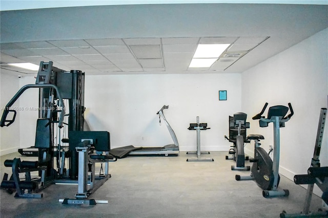 exercise room with a paneled ceiling