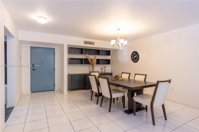 dining space with a notable chandelier and light tile patterned floors