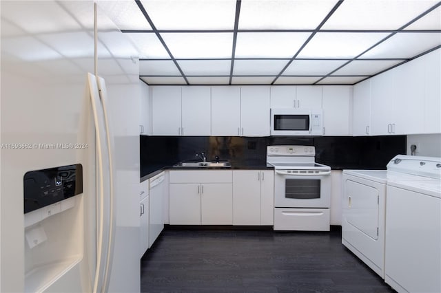 kitchen featuring white cabinets, white appliances, sink, and separate washer and dryer