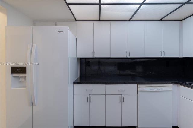 kitchen with white cabinets, white appliances, and tasteful backsplash