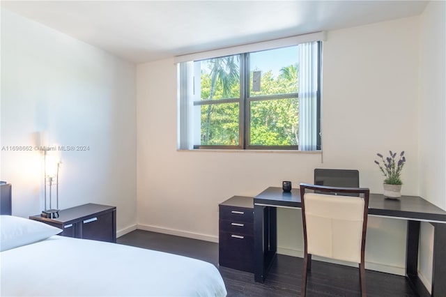 bedroom with dark hardwood / wood-style flooring