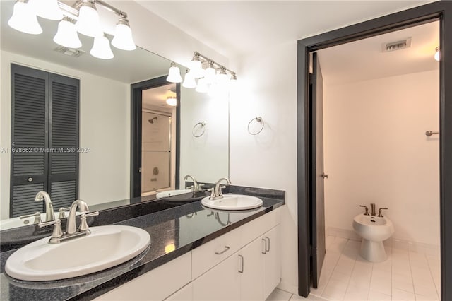 bathroom with vanity, tile patterned flooring, and a bidet