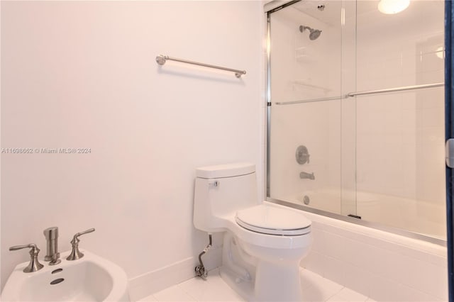 full bathroom featuring sink, tile patterned floors, a bidet, toilet, and shower / bath combination with glass door