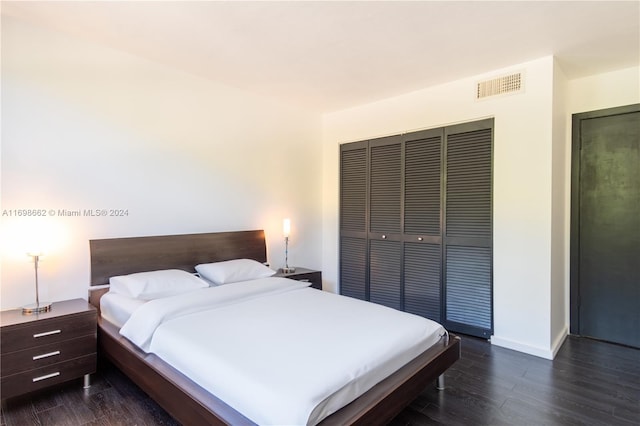 bedroom featuring a closet and dark wood-type flooring