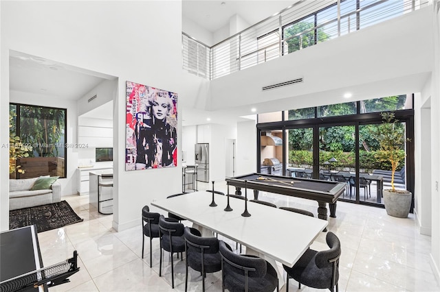 dining area featuring a wealth of natural light, a high ceiling, billiards, and french doors