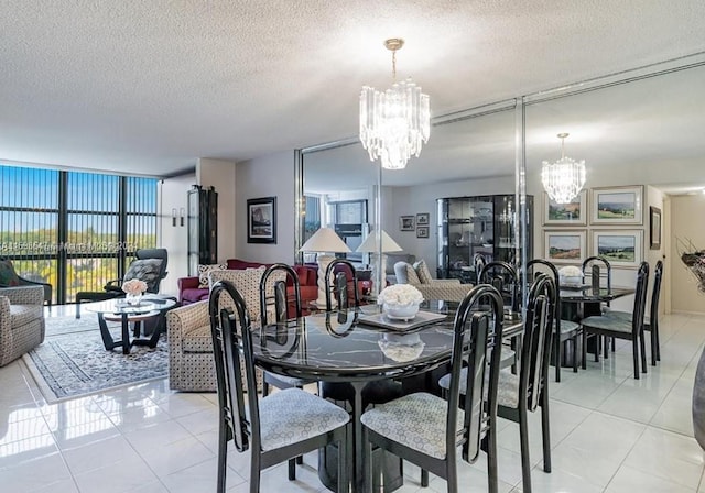 tiled dining room with a chandelier, a textured ceiling, and a wall of windows