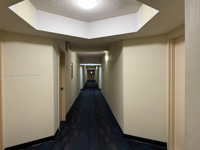 corridor with a textured ceiling