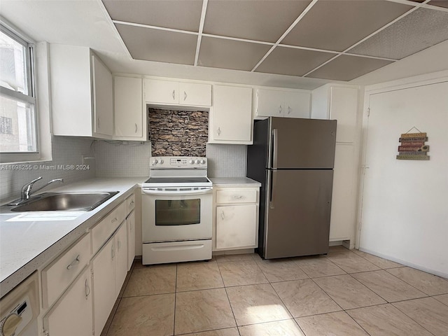 kitchen featuring stainless steel fridge, backsplash, sink, white electric range, and white cabinetry