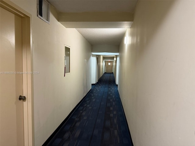 hallway with dark hardwood / wood-style flooring and electric panel