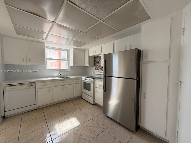 kitchen featuring white cabinetry and white appliances