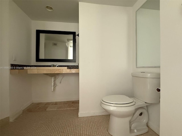 bathroom featuring tile patterned flooring and toilet