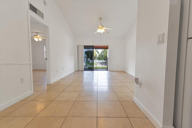 spare room featuring ceiling fan, light tile patterned floors, and high vaulted ceiling